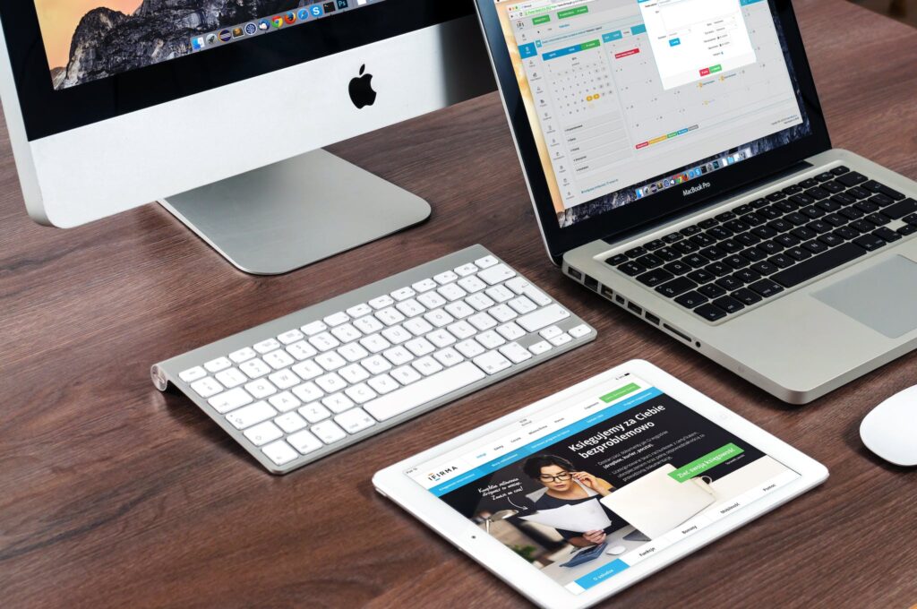 Turned on Imac Beside Macbook on Table make niche site attractive to buyers